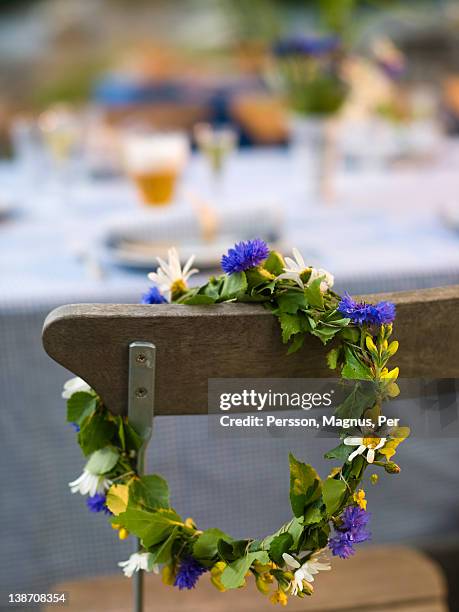 flower wreath hanging on chair - solstice stock pictures, royalty-free photos & images