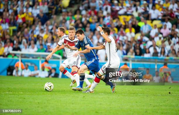 Lionel Messi of Argentina, Toni Kroos and Mesut Oezil of Germany during the World Cup Final match between Germany and Argentina at the Maracana...