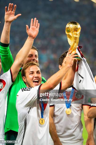 Mario Goetze of Germany and goal scorer raises the World Cup trophy with teammates. World Cup Final match between Germany and Argentina at the...