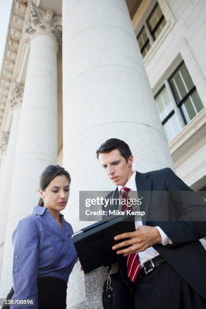 caucasian business people looking at digital tablet - collaboration government stock pictures, royalty-free photos & images