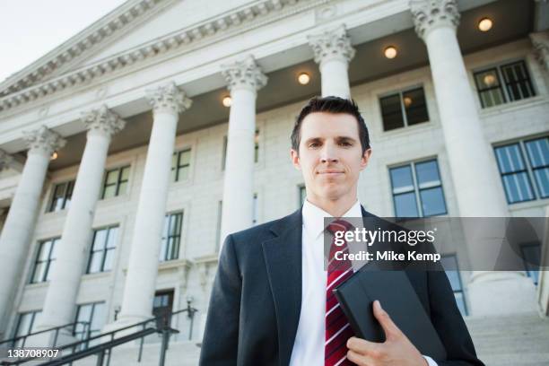 caucasian businessman standing outdoors - overheidsberoep stockfoto's en -beelden