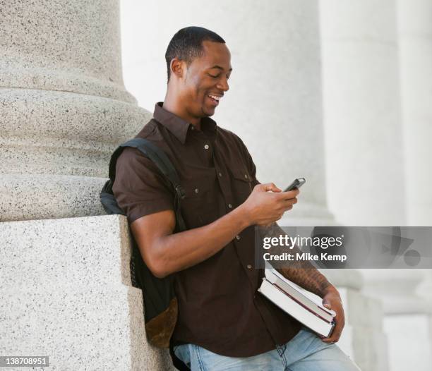 black college student text messaging on cell phone - university of utah imagens e fotografias de stock