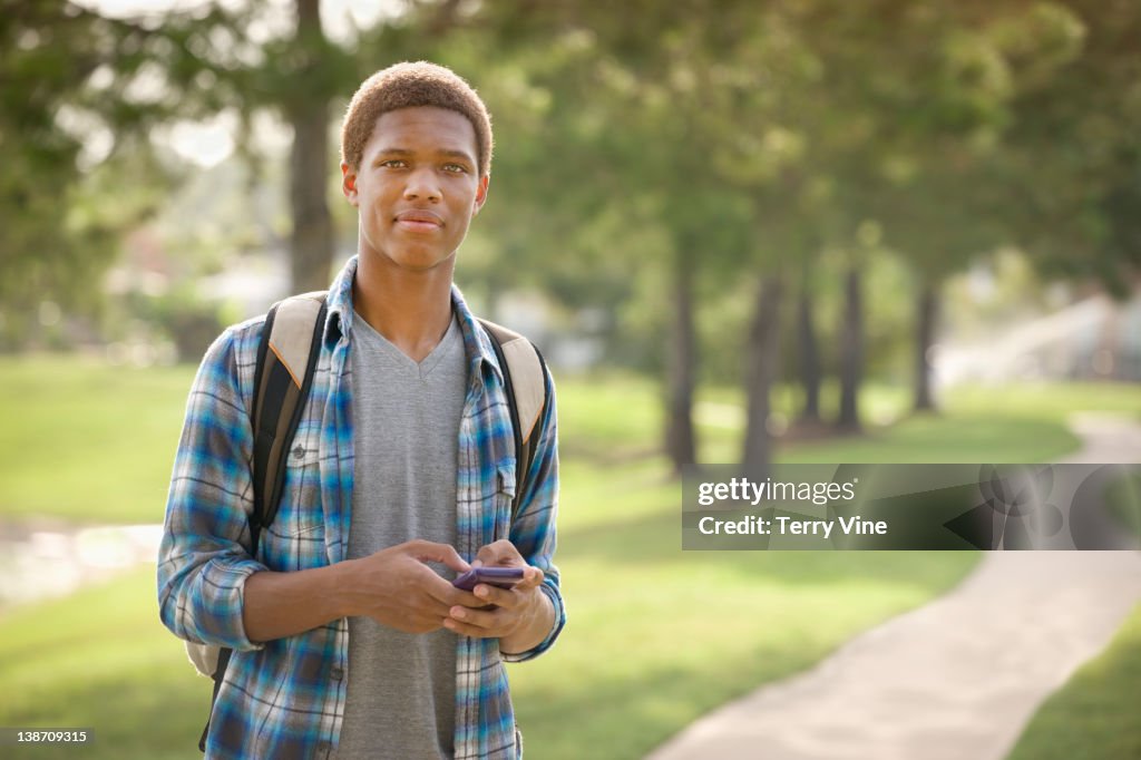 Mixed race teenager text messaging on cell phone