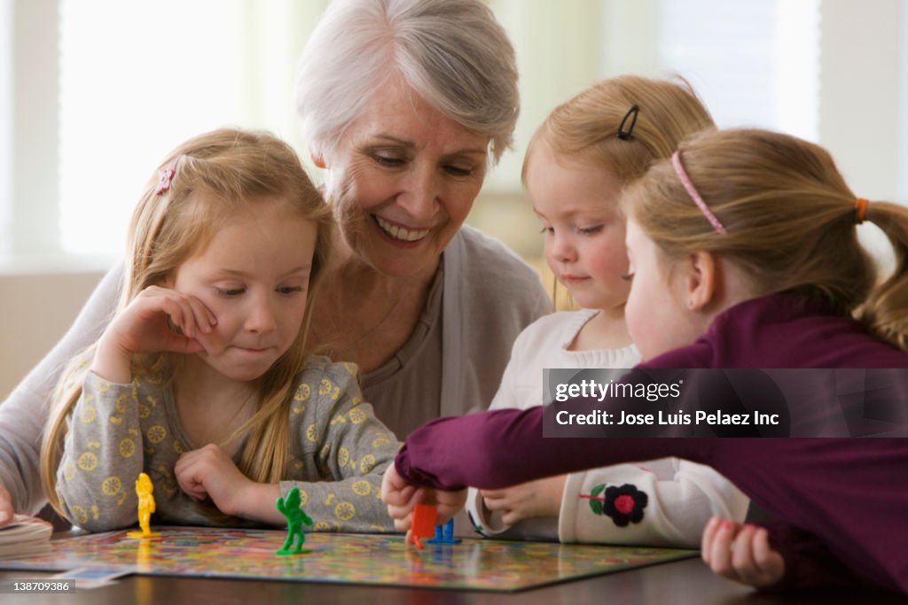 Caucasian grandmother and granddaughters playing game together