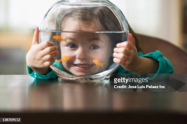 caucasian girl holding fish bowl - goldfish bowl stock pictures, royalty-free photos & images