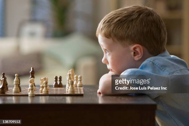 caucasian boy playing chess - kids playing chess stock pictures, royalty-free photos & images