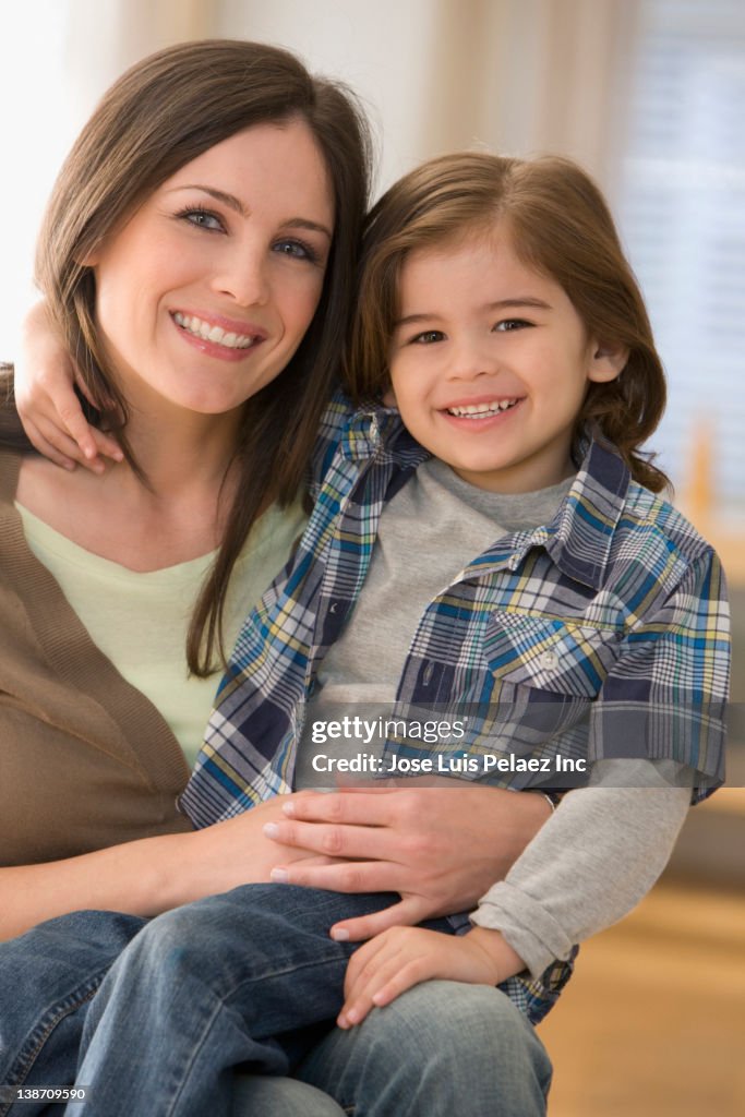 Mixed race boy sitting on mother's lap