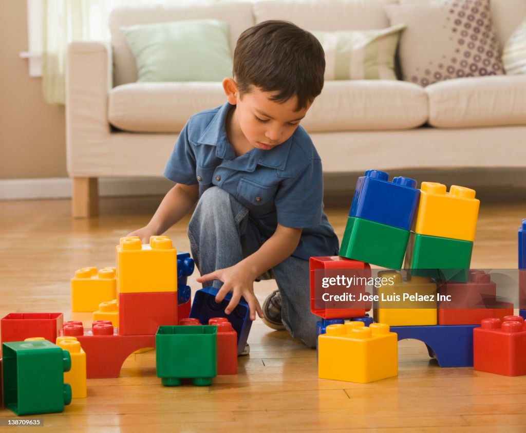 Hispanic boy playing with building blocks