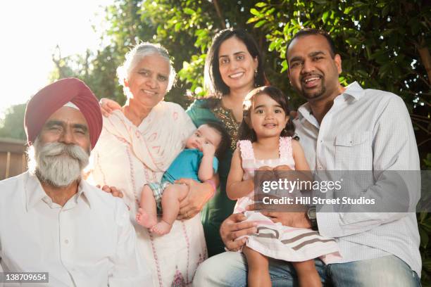 smiling multi-generation asian family - indian ethnicity family stock pictures, royalty-free photos & images