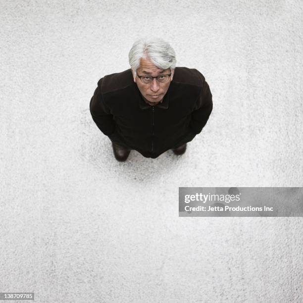 asian businessman standing in lobby - person look up from above stock pictures, royalty-free photos & images