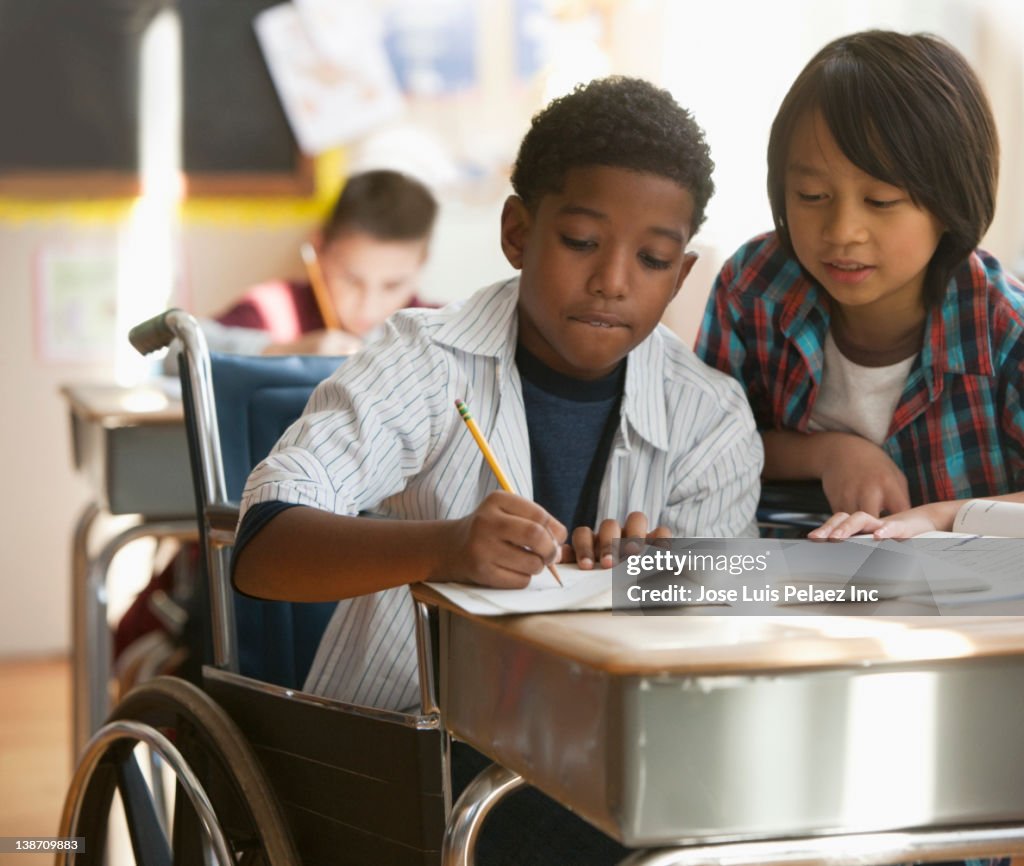 Boys doing schoolwork together