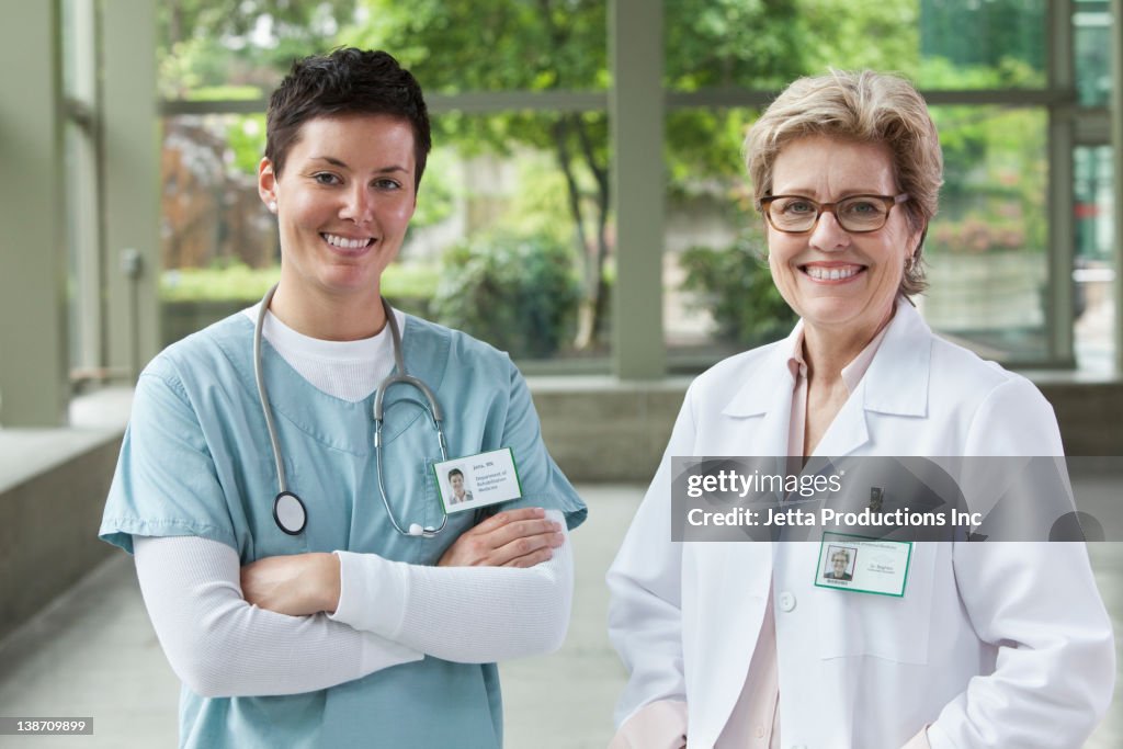 Caucasian doctors standing together in lobby