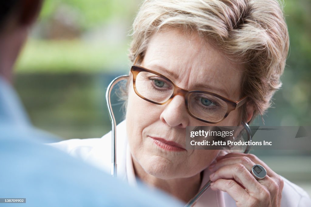 Caucasian doctor examining patient