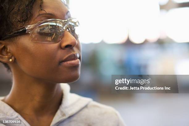 black worker in protective eyewear - protective eyewear stock pictures, royalty-free photos & images