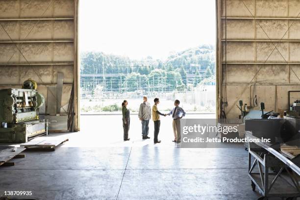 workers talking to boss in warehouse - factory door stock pictures, royalty-free photos & images