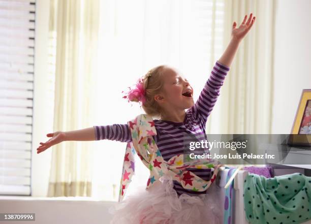 caucasian girl singing with arms outstretched - girl dressing up stock pictures, royalty-free photos & images