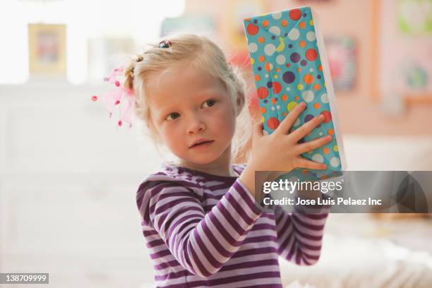 caucasian girl holding birthday gift - kids birthday present stock pictures, royalty-free photos & images