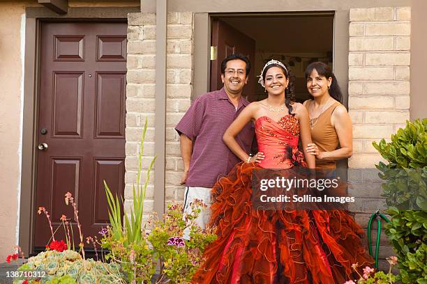 hispanic girl dressed for quinceanera standing with parents - 15th birthday stock pictures, royalty-free photos & images