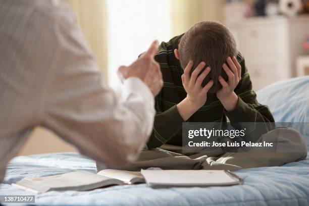 Father Lecturing Son In Bedroom High-Res Stock Photo