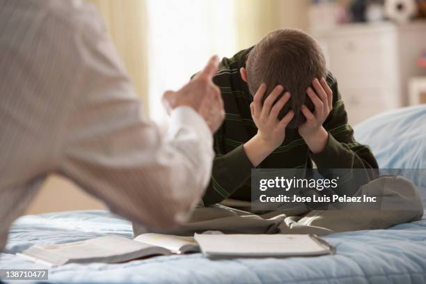 father lecturing son in bedroom - children shouting stock pictures, royalty-free photos & images