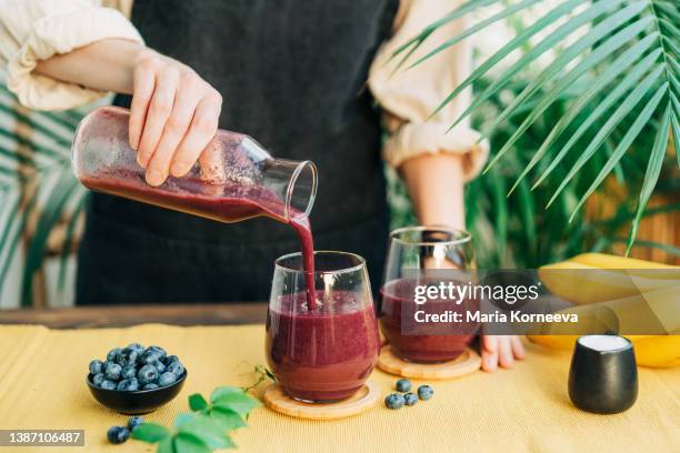 fresh blueberry smoothie in glass. - purple berry plant stock pictures, royalty-free photos & images