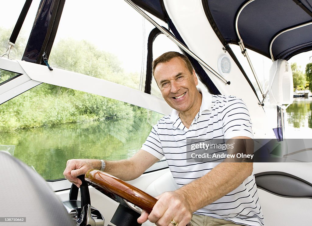 Man driving boat on river