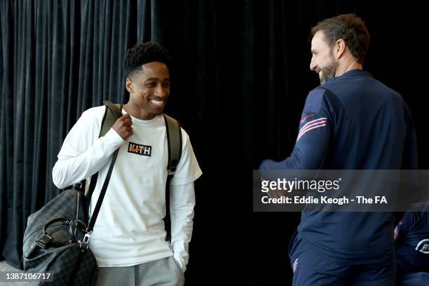 Kyle Walker-Peters of England is greeted by Gareth Southgate, Manager of England as he arrives at St Georges Park on March 22, 2022 in...