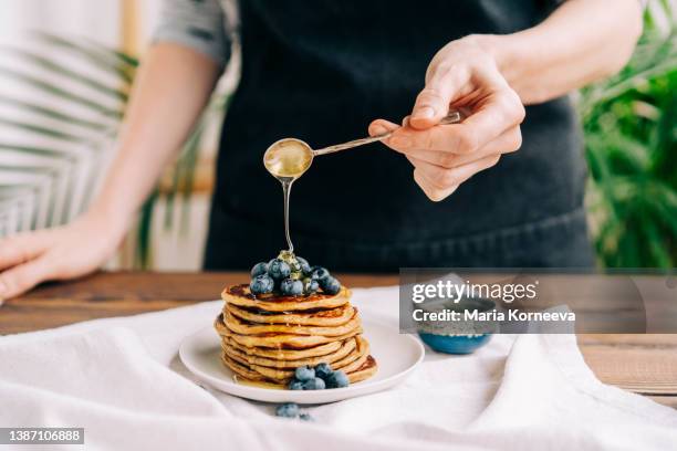 homemade pancakes  with blueberries and honey. - maple syrup pancakes stock pictures, royalty-free photos & images