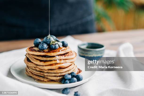 homemade pancakes  with blueberries and honey. - making pancakes stock pictures, royalty-free photos & images