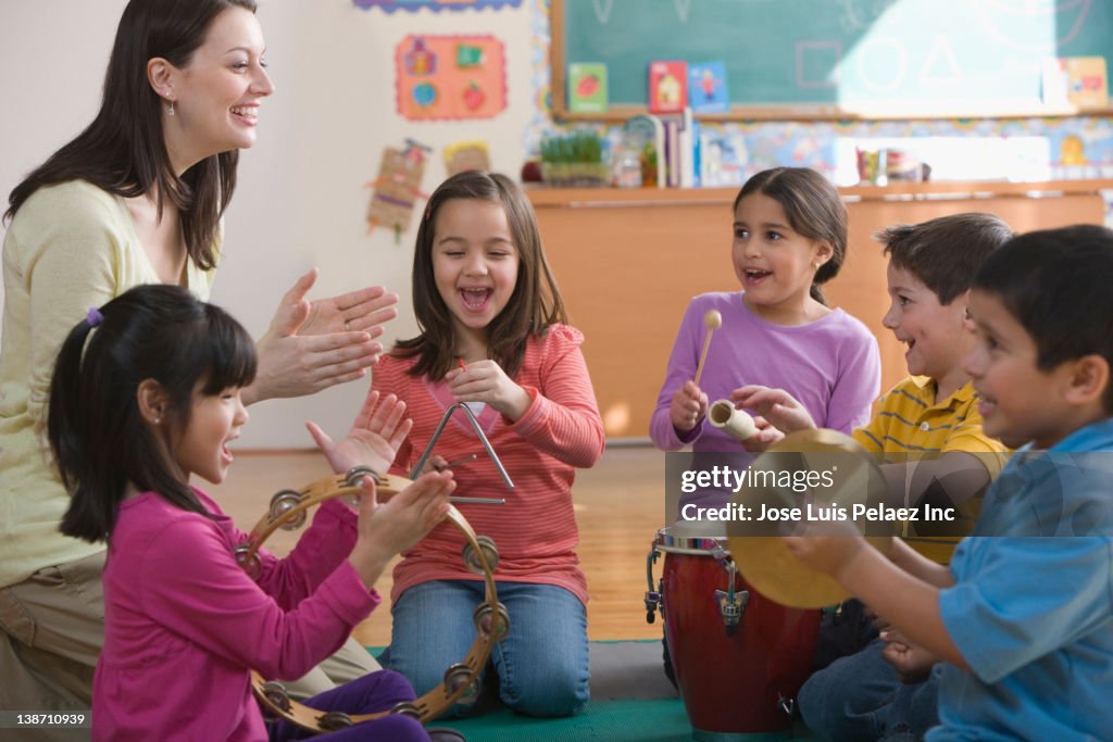 Students playing musical instruments in classroom