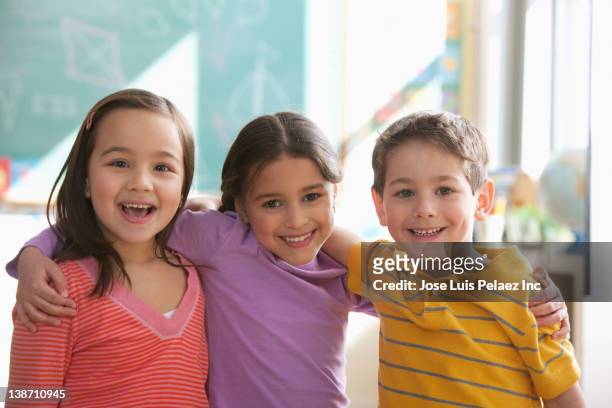 students standing together in classroom - 6 7 years stock pictures, royalty-free photos & images
