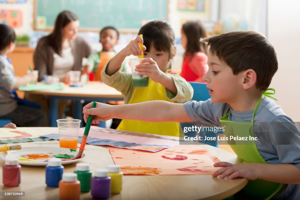 Students painting in art class