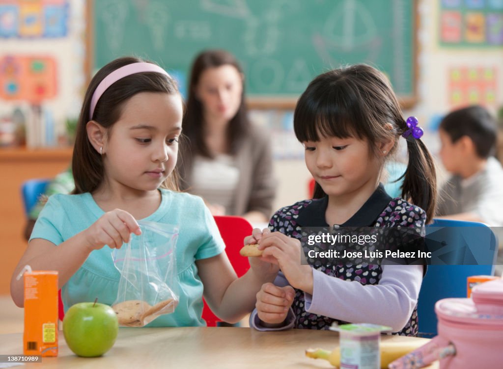 Girls eating lunch together in classroom