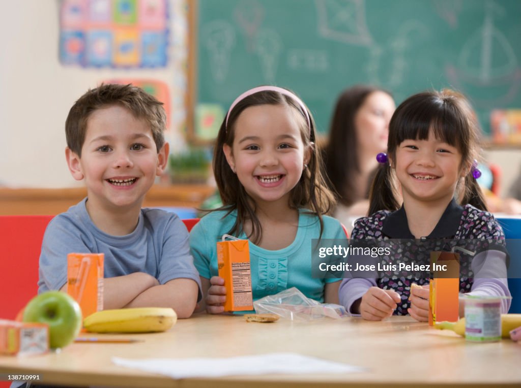 Students eating lunch together in classroom