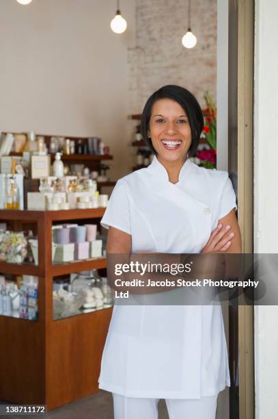 aesthetician standing in beauty product store - esthetician stock-fotos und bilder