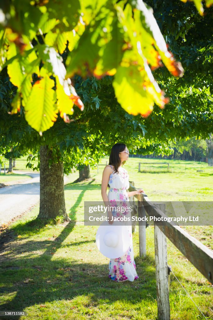 Glamorous Hispanic woman standing in park