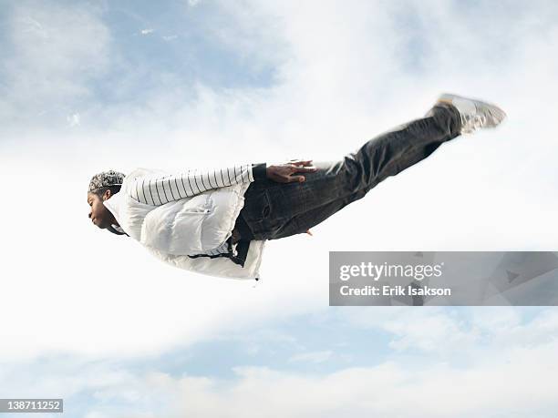 african american man flying through mid-air - trampoline man stock pictures, royalty-free photos & images