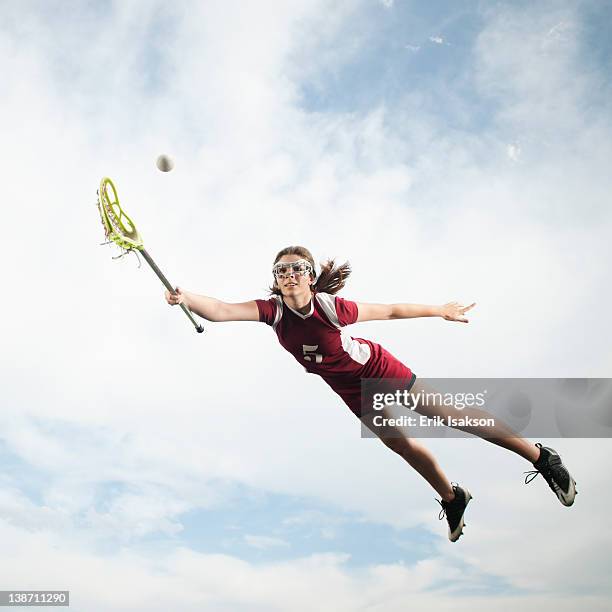 caucasian teenager in mid-air playing lacrosse - lacrosse 個照片及圖片檔