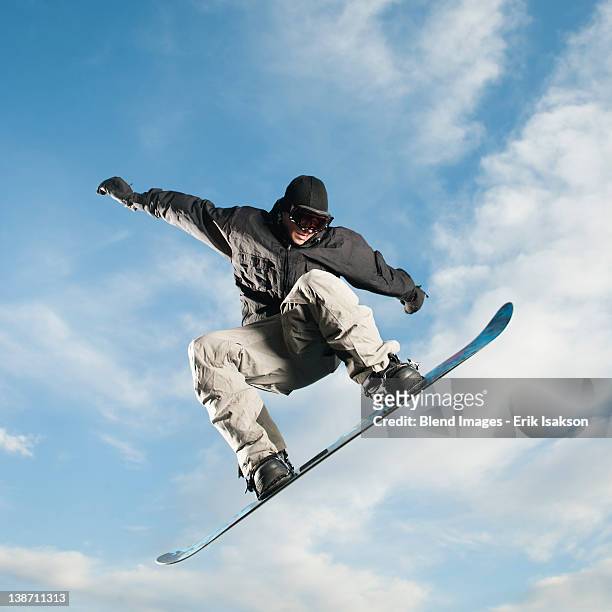 caucasian man on snowboard in mid-air - snowboard jump bildbanksfoton och bilder