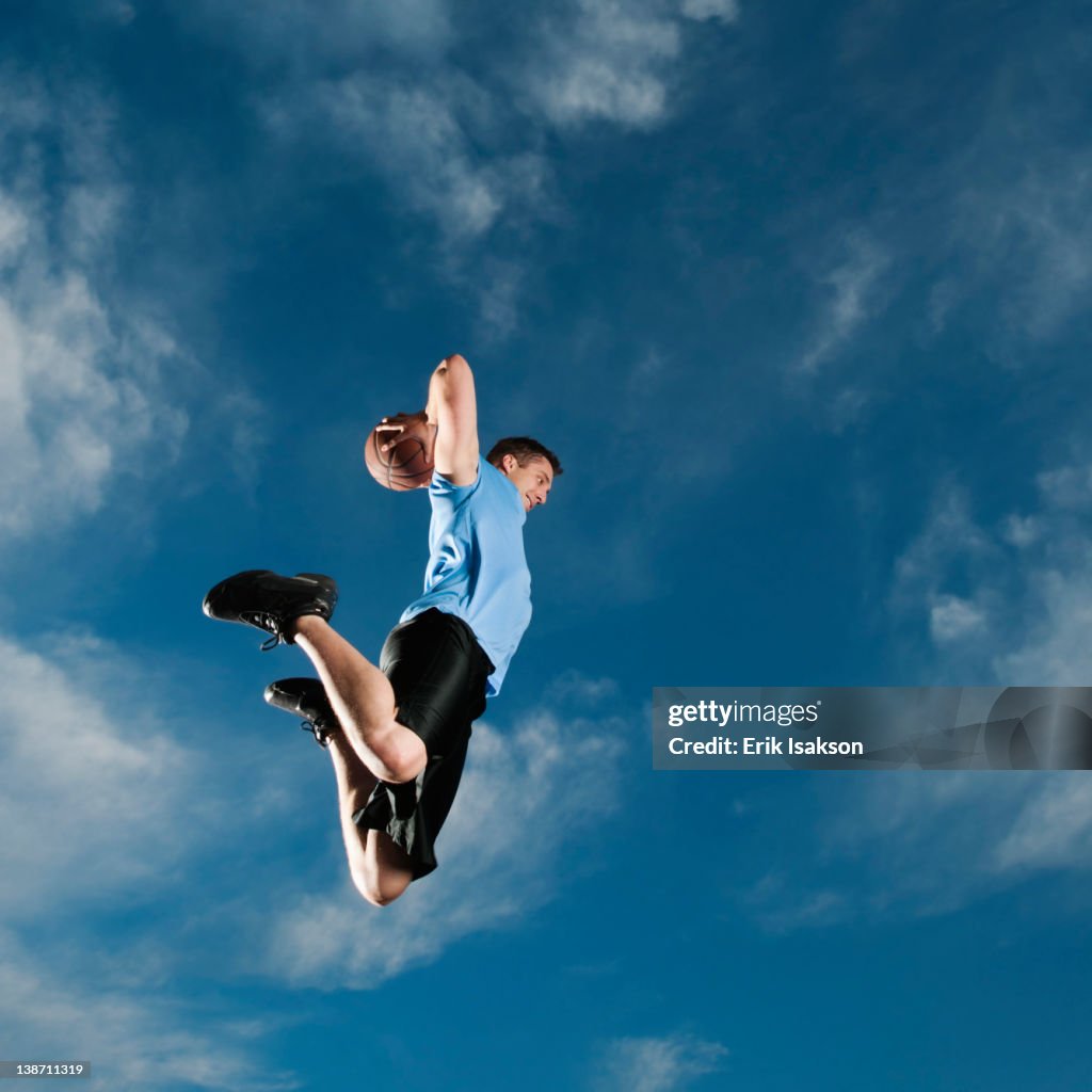Caucasian man playing basketball