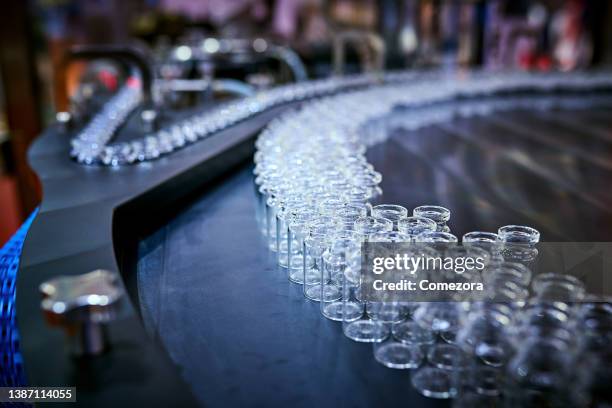 transparent glass bottles at production line - phialide stock pictures, royalty-free photos & images