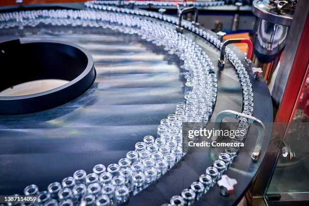 transparent glass bottles at production line - phialide stock pictures, royalty-free photos & images