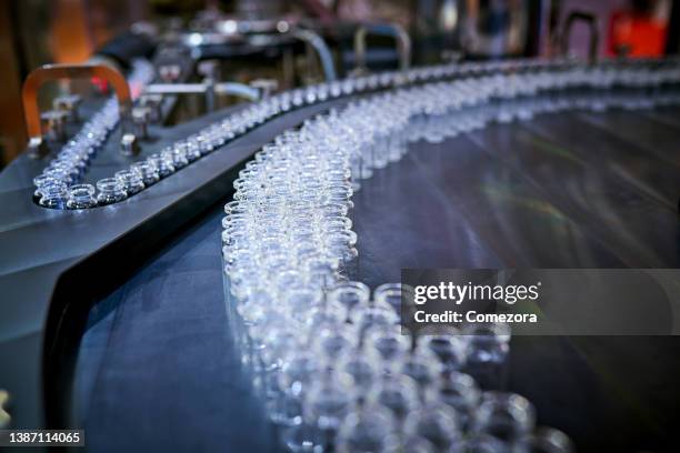 transparent glass bottles at production line - phialide stock pictures, royalty-free photos & images