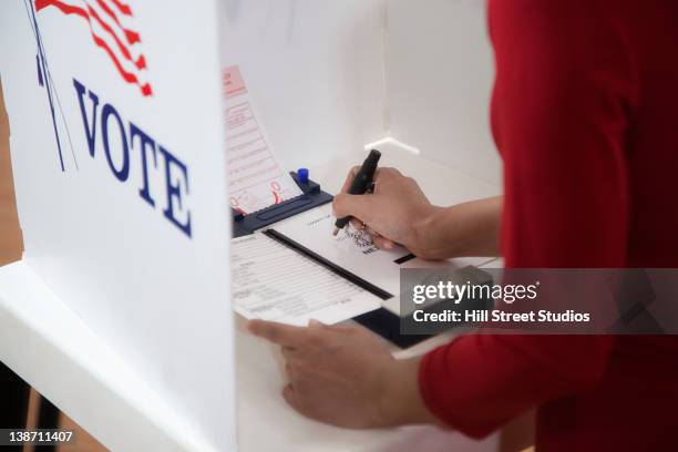 asian voter voting in polling place - politische wahl stock-fotos und bilder