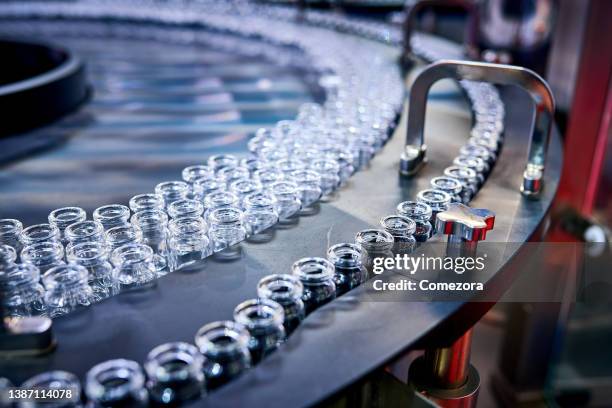 transparent glass bottles at production line - phialide stock pictures, royalty-free photos & images