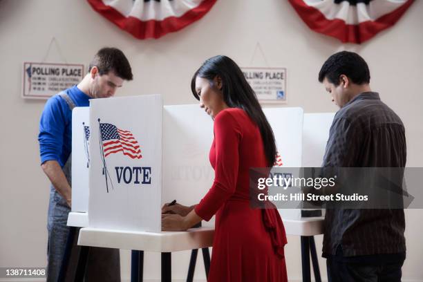 voters voting in polling place - voting booth stock pictures, royalty-free photos & images