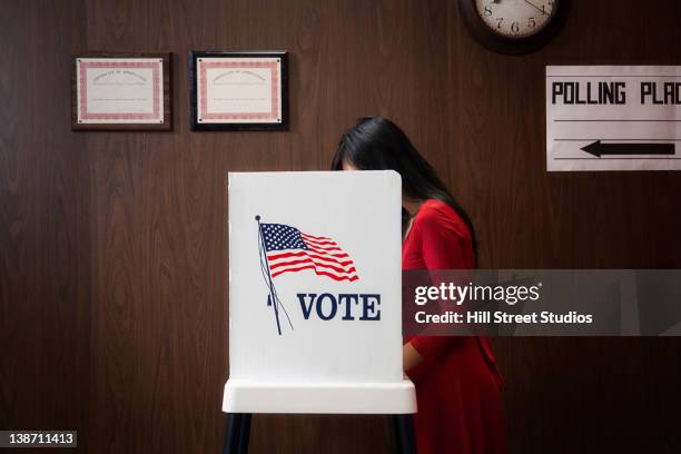 asian voter voting in polling place - wahllokal stock-fotos und bilder