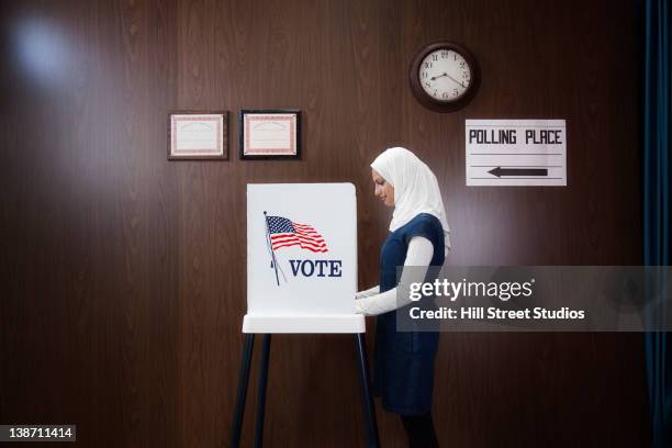 middle eastern voter voting in polling place - voting booth stock pictures, royalty-free photos & images