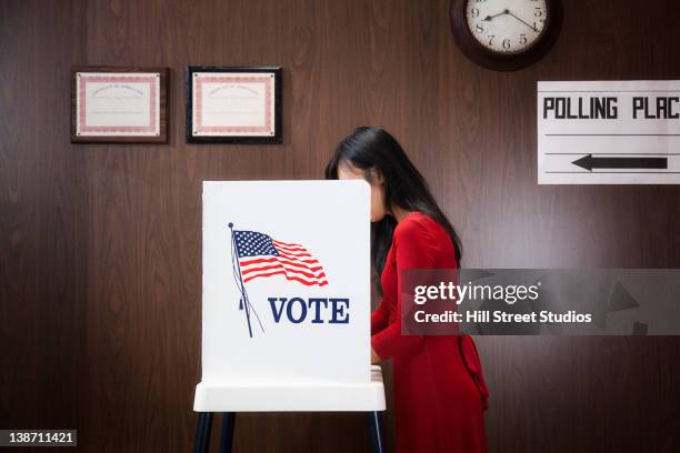 asian voter voting in polling place - voting booth stock pictures, royalty-free photos & images