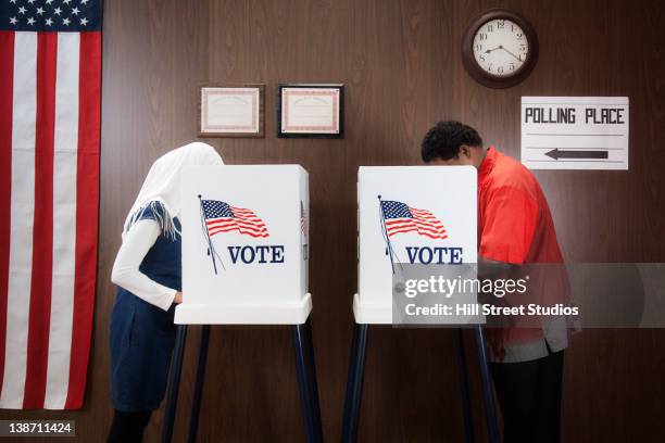 voters voting in polling place - polling booth stockfoto's en -beelden